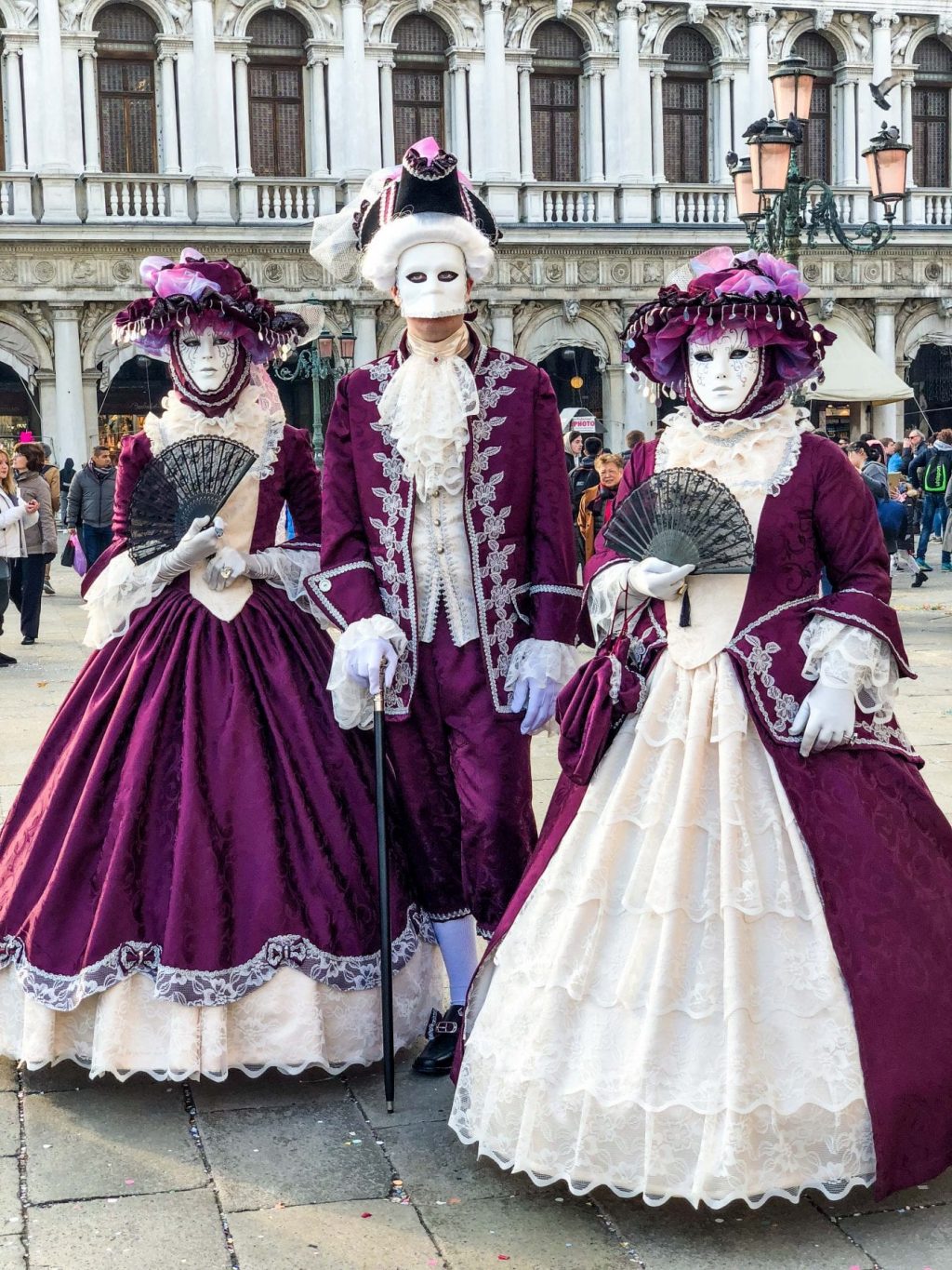 Elegant people in masquerade carnival mask at Venice Carnival